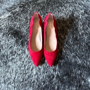 Kate Spade red pumps with petal shape side detail. Never worn.